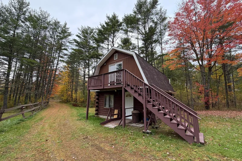 $139,900 Maine Log Cabin With 14 Acres and 350 Feet of Stream Frontage